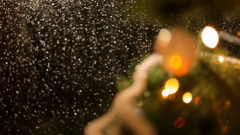 Drops of rain on New Year window glass on the background of the Christmas toys. Video stock 70768096