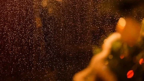 Drops of rain on New Year window glass on the background of the Christmas toys. Stock Footage 70768543