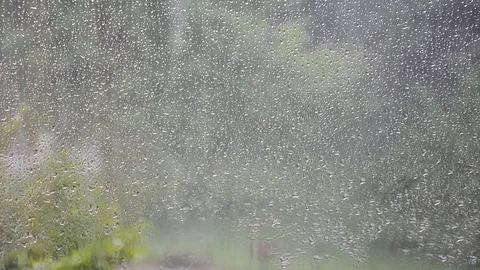 Drops of rain over the window in spring in real time Stock Footage 89691275