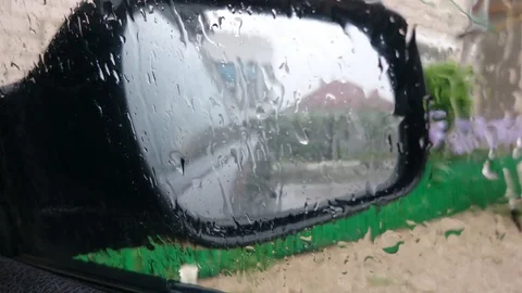 Drops of rain run down the glass of car in the mirror of the rear view mirror 스톡 동영상 91940181