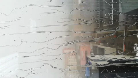 Drops of rain run down the glass of the window Stock Footage 167098934