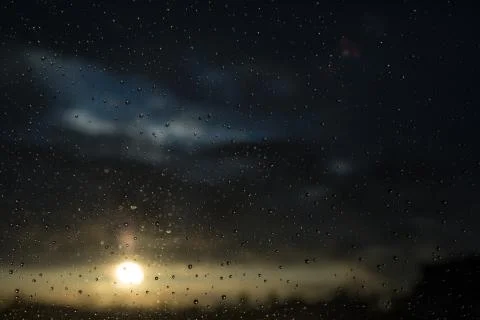Drops of rain on window after a storm. Water drops on the glass after rain. Stock Photos