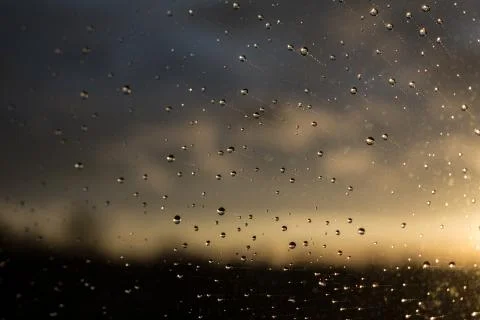 Drops of rain on window after a storm. Water drops on the glass after rain. Stock Photos