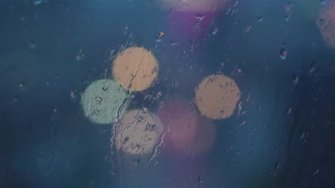 Drops of rain on the window and glare of light on the background 库存影片 76612566