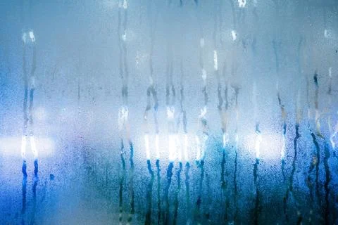 Drops of rain on window with.background abstract bokeh lights. copy space bac Foto stock