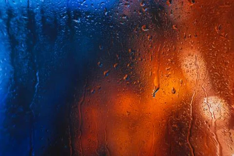 Drops of rain on the window of the car in the evening Stock Photos