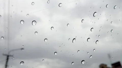 Drops of rain on a window with a gray sky behind Stock Footage 91707992