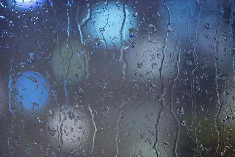 Drops of rain on window, night. Stock Photos