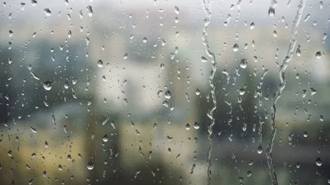 Drops of rain on a window pane, buildings in background Stock Footage 83389185