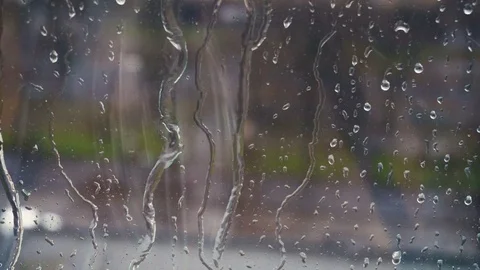 Drops of rain on a window pane, buildings in background. Stock Footage 83390216