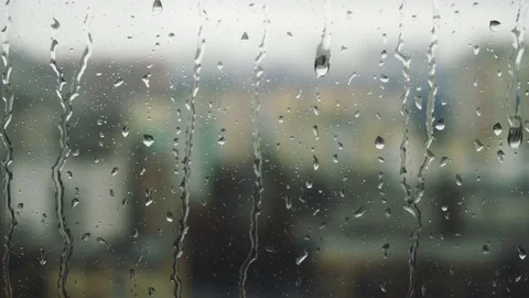 Drops of rain on a window pane, buildings in background Stock Footage 83391268