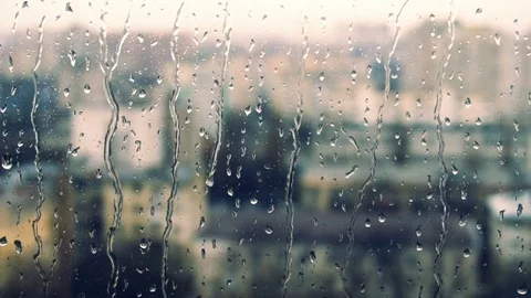 Drops of rain on a window pane, buildings in background Stock Footage 83391378