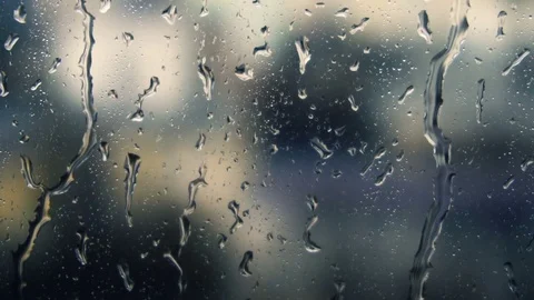 Drops of rain on a window pane, buildings in background Stock Footage 83392004