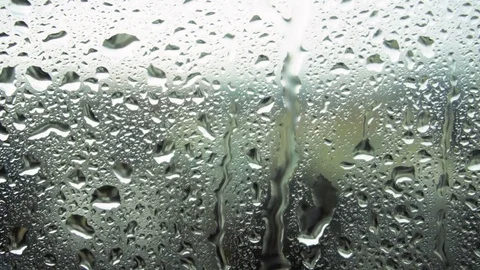 Drops of rain on a window pane, buildings in background Stock Footage 83392246