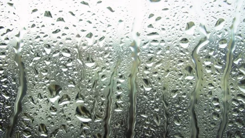 Drops of rain on a window pane, buildings in background Stock Footage 83392417