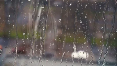 Drops of rain on a window pane, buildings in background. Stock Footage 83430404