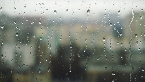 Drops of rain on a window pane, buildings in background Stock Footage 83430860