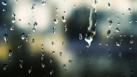 Drops of rain on a window pane, buildings in background Stock Footage 83431140