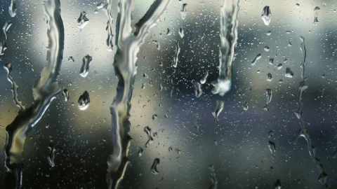 Drops of rain on a window pane, buildings in background Stock Footage 83431202