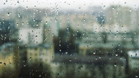 Drops of rain on a window pane, buildings in background Video stock 83542114