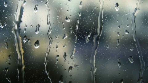 Drops of rain on a window pane, buildings in background Video stock 83542290