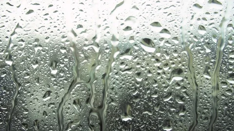 Drops of rain on a window pane, buildings in background Video stock 83542405
