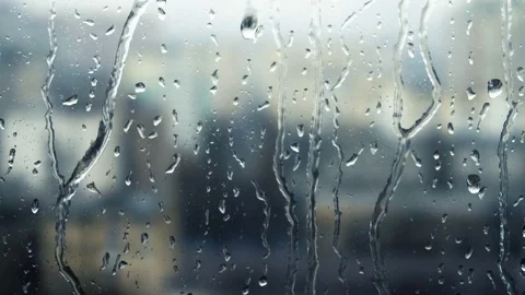 Drops of rain on a window pane, buildings in background Stock Footage 83578342