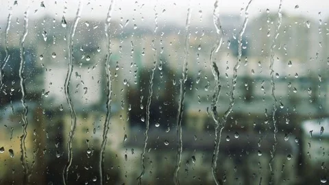Drops of rain on a window pane, buildings in background Stock Footage 83578843