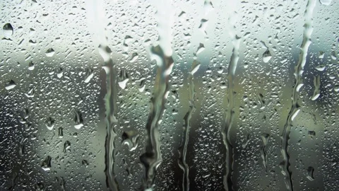 Drops of rain on a window pane, buildings in background Stock Footage 83579497
