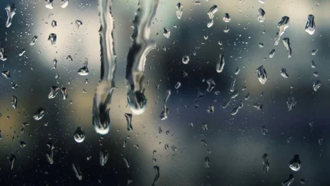 Drops of rain on a window pane, buildings in background Stock Footage 83610991