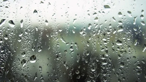 Drops of rain on a window pane, buildings in background Stock Footage 83611307