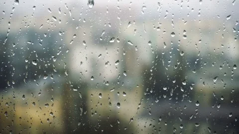 Drops of rain on a window pane, buildings in background Stock Footage 83716069