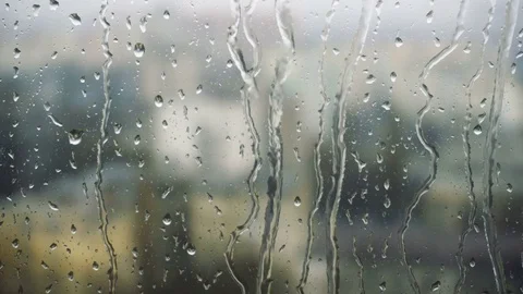 Drops of rain on a window pane, buildings in background Stock Footage 83716665