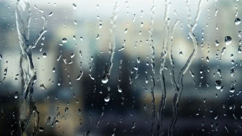 Drops of rain on a window pane, buildings in background Stock Footage 83716827
