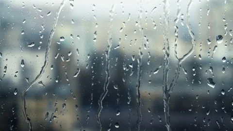 Drops of rain on a window pane, buildings in background Stock Footage 83716880