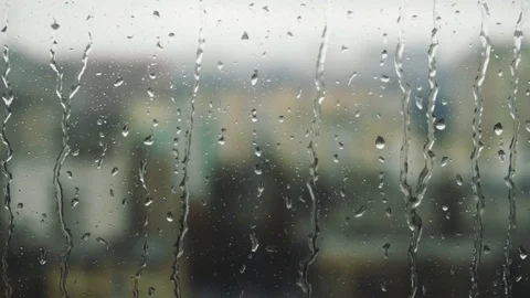 Drops of rain on a window pane, buildings in background Stock Footage 83716956