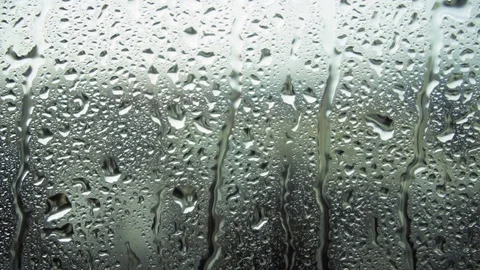 Drops of rain on a window pane, buildings in background Stock Footage 83717131