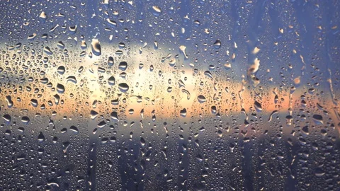 Drops of rain on a window pane, buildings in background Stock Footage 83787931