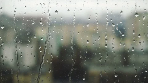 Drops of rain on a window pane, buildings in background Video stock 84255220