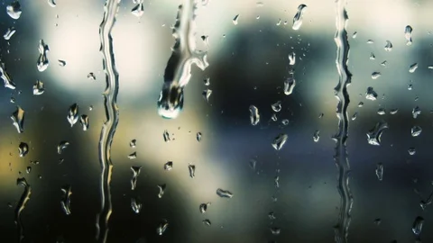 Drops of rain on a window pane, buildings in background Video stock 84255624