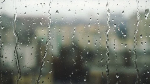 Drops of rain on a window pane, buildings in background Stock Footage 84295970