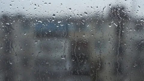 Drops of rain on a window pane, buildings in background. Stock Footage 87134741