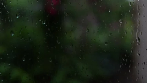 Drops of rain on a window pane, house and garden in background 스톡 동영상 157358479