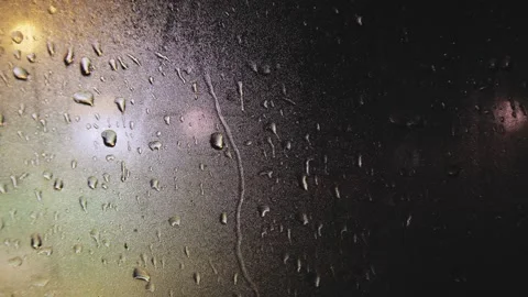 Drops of rain on the window in the rays of night illumination Video stock 246636306