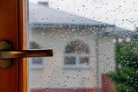 Drops of rain on the window. View from the window of the house Fotos de archivo