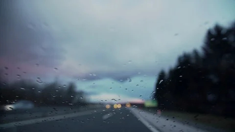 Drops of rain on a windshield in a driving car Video stock 103217780