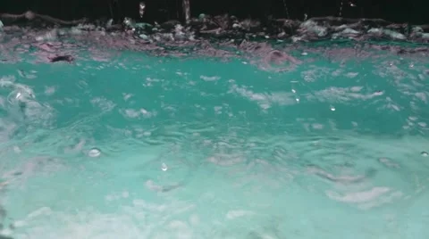 Drops of raining water hitting the surface of swimming pool Stock Footage 41335284