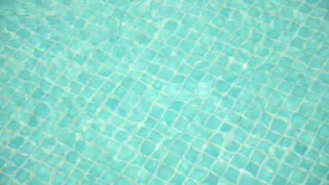 Drops of Rainwater falling on the Surface of a Swimming Pool. Blurred tiles.. Stock Footage 245460620