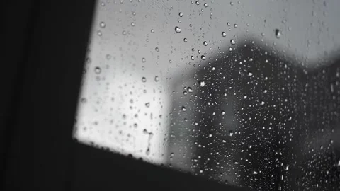 Drops of rainwater slide down a window Stock Footage 259221717
