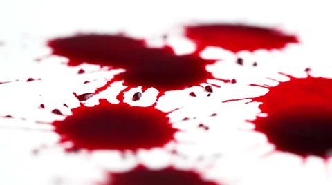 Drops of red liquid on white background Stock Footage 42985894